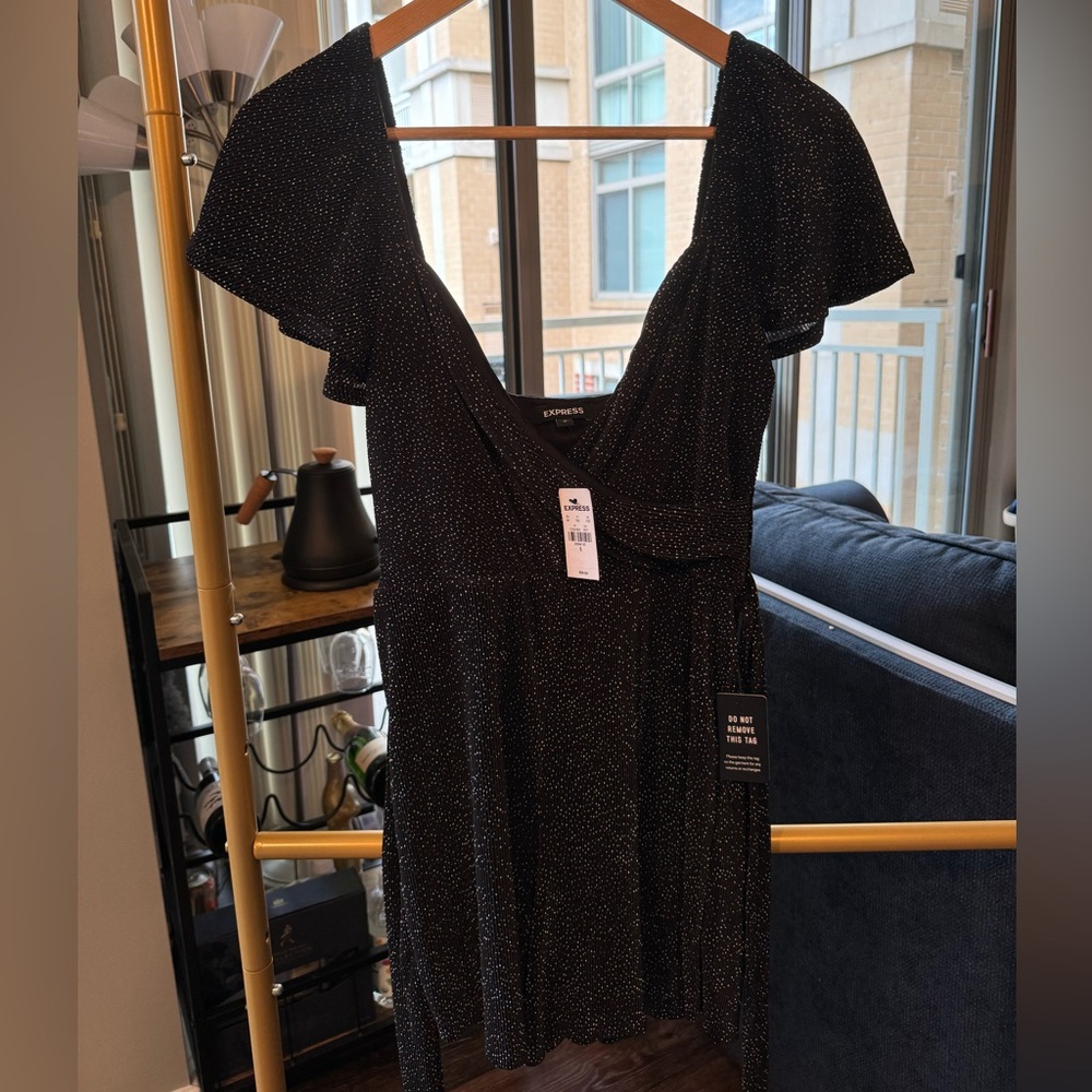 NEW WITH TAGS Dreamy Black Romper with Polka Dots (X). Wrap front and waist tie